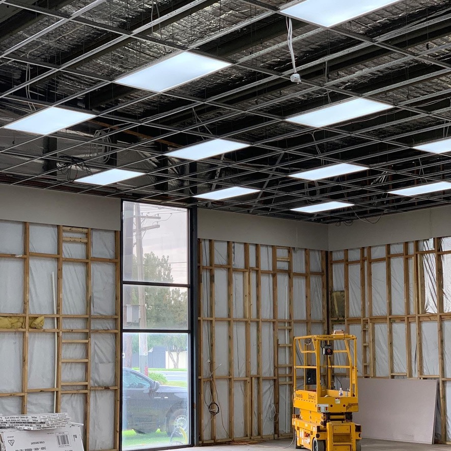 LED panel lights installed in the ceiling grid of a new tenancy during fit-out