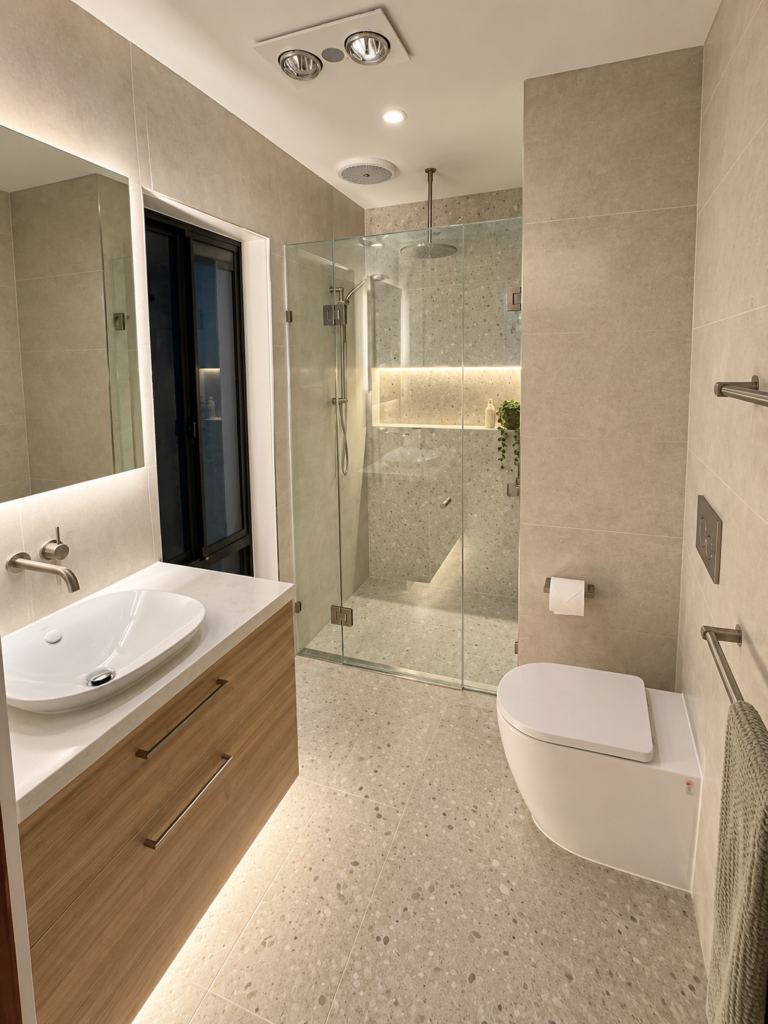 Renovated bathroom with timber vanity, backlit mirror, glass shower screen and lit shower niche
