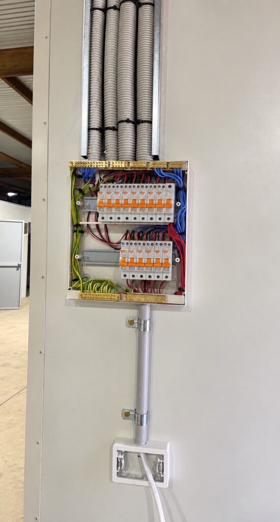 Switchboard with circuit breakers and safety switches wired into conduit during installation
