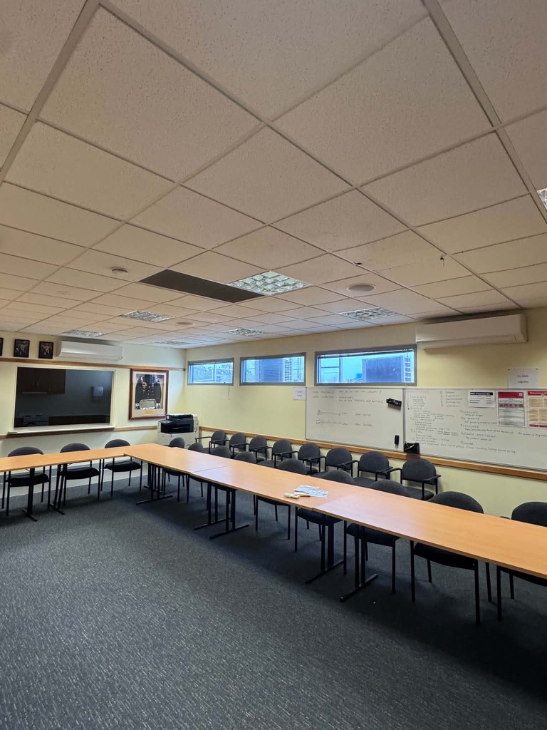 Meeting room with LED panel lighting and a wall-mounted air conditioner