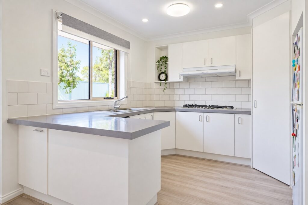 Kitchen with an oyster ceiling light and LED downlights