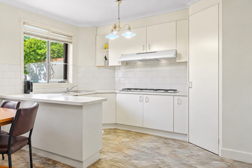 Kitchen with a pendant light and downlights