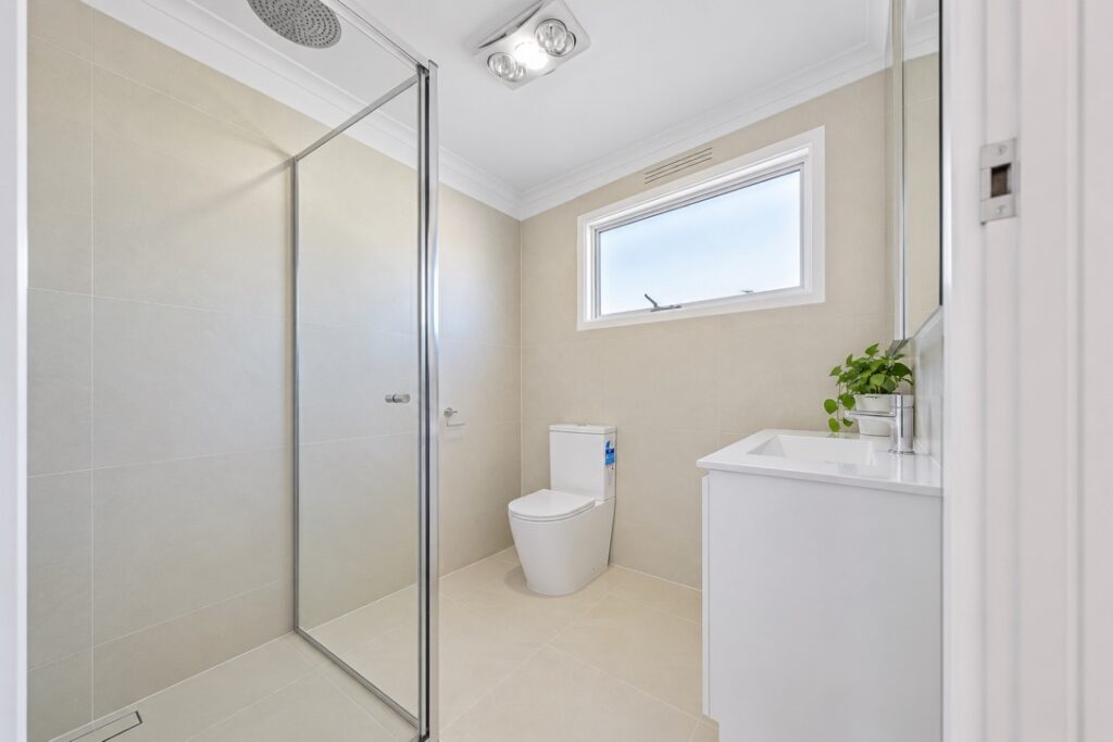 Bathroom with a ceiling heat, fan and light unit
