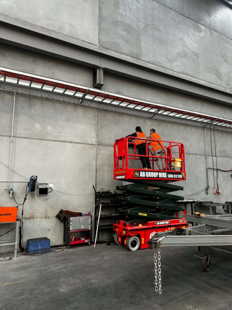 Factory lighting installed from a scissor lift