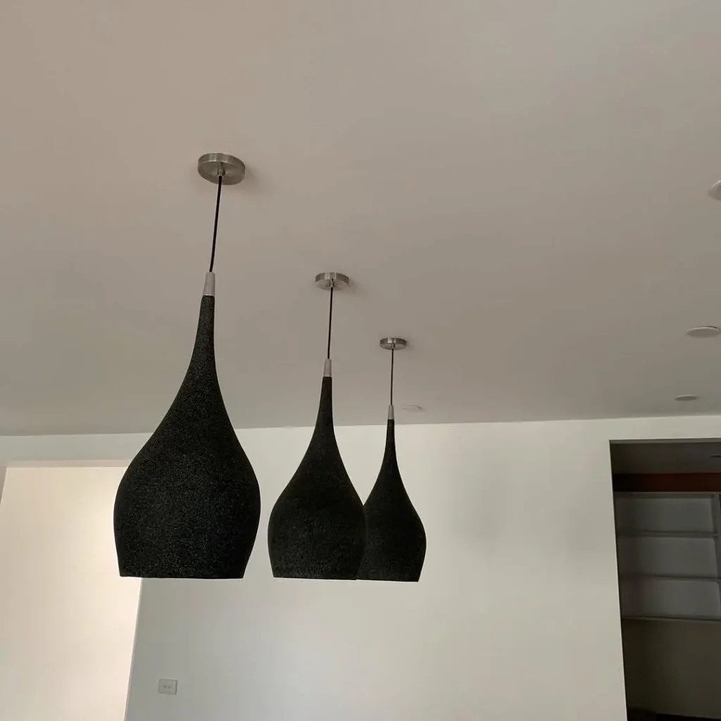 Three black pendant lights hung at staggered heights