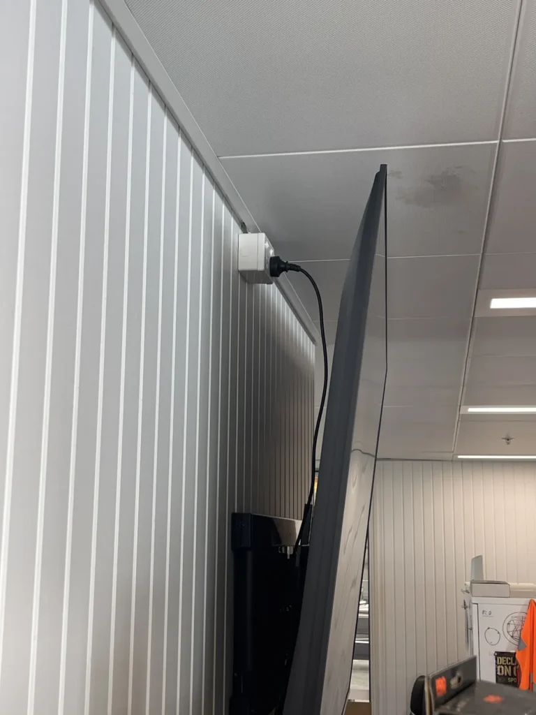 Power point installed behind a wall-mounted TV