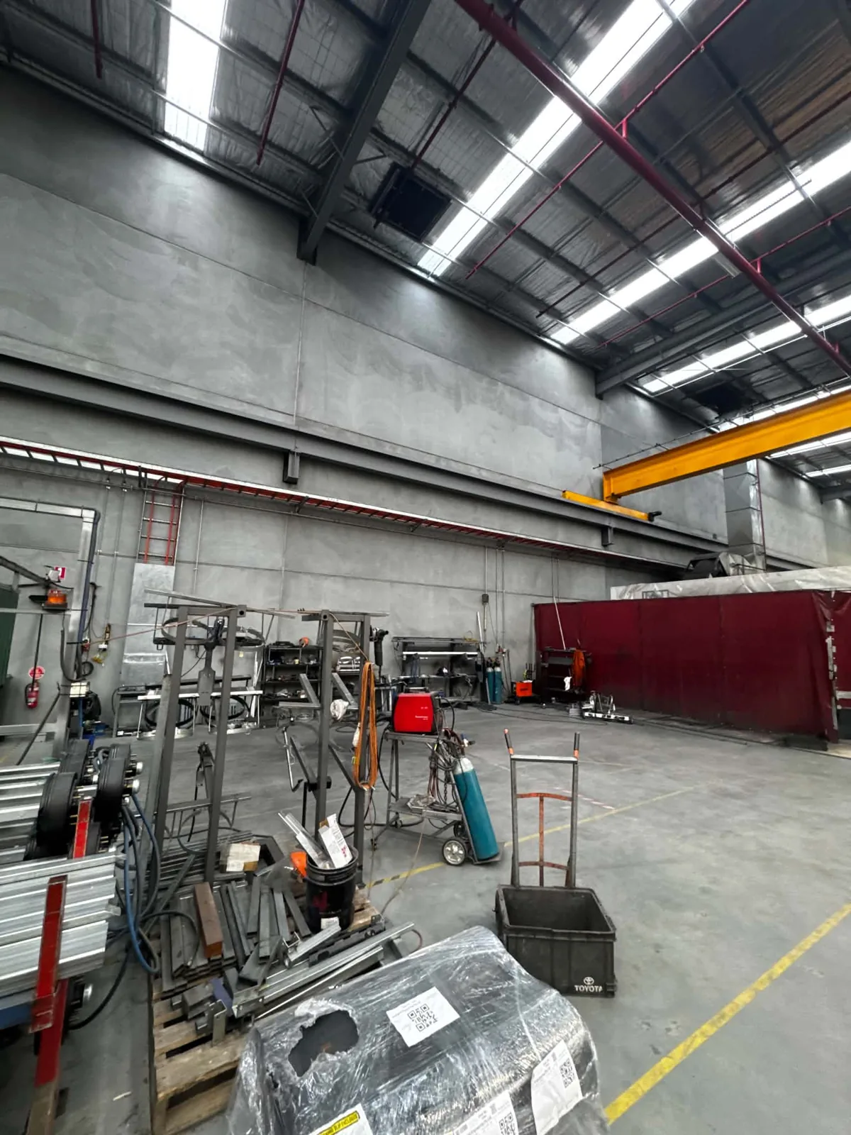 Fabrication workshop with LED high-bay lighting and an overhead crane