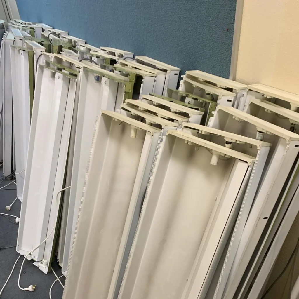 Old fluorescent light fittings removed during an LED lighting upgrade