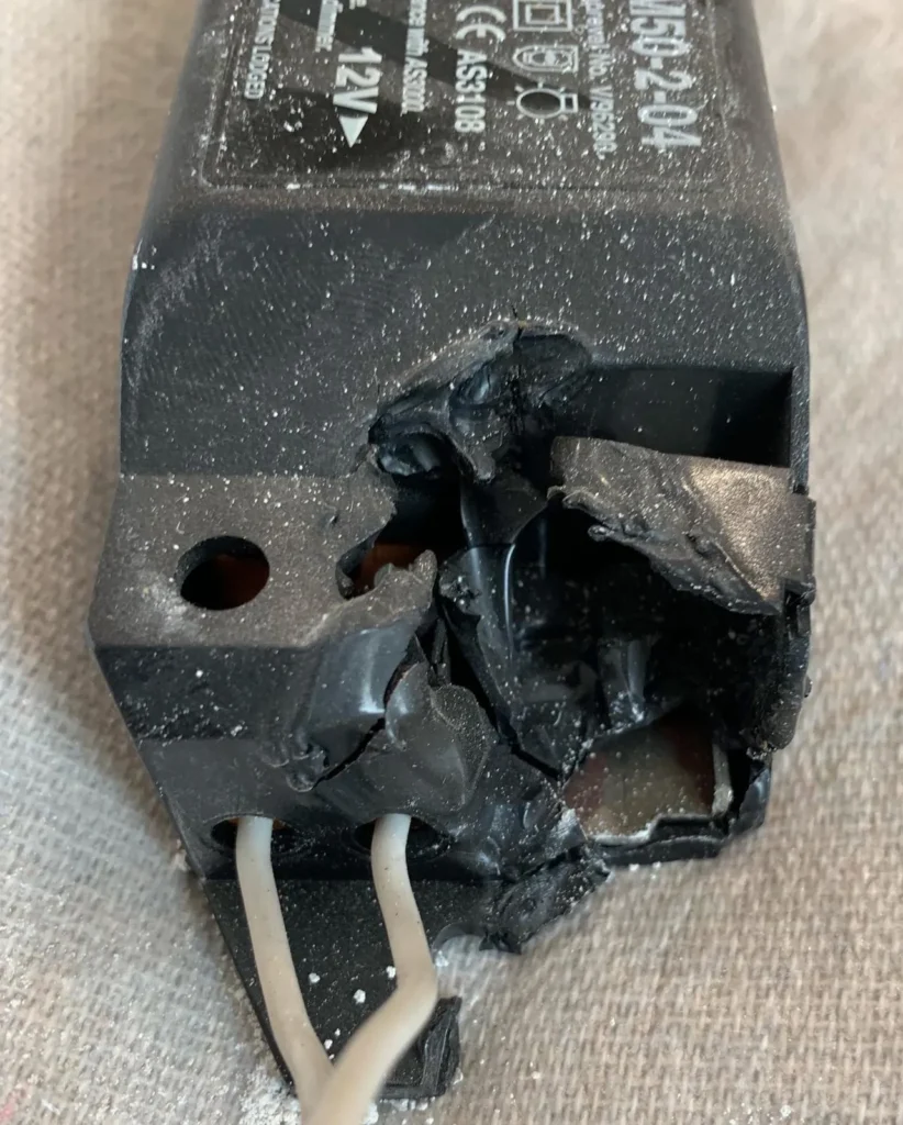 Heat-damaged downlight driver with melted casing