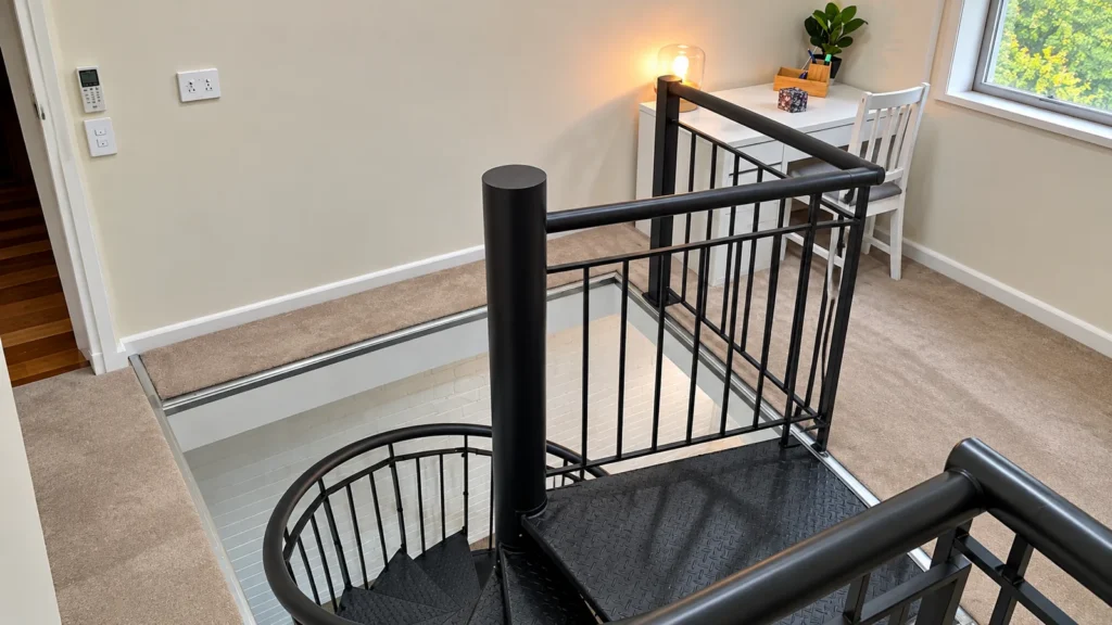 Internal staircase with a black steel balustrade after renovation