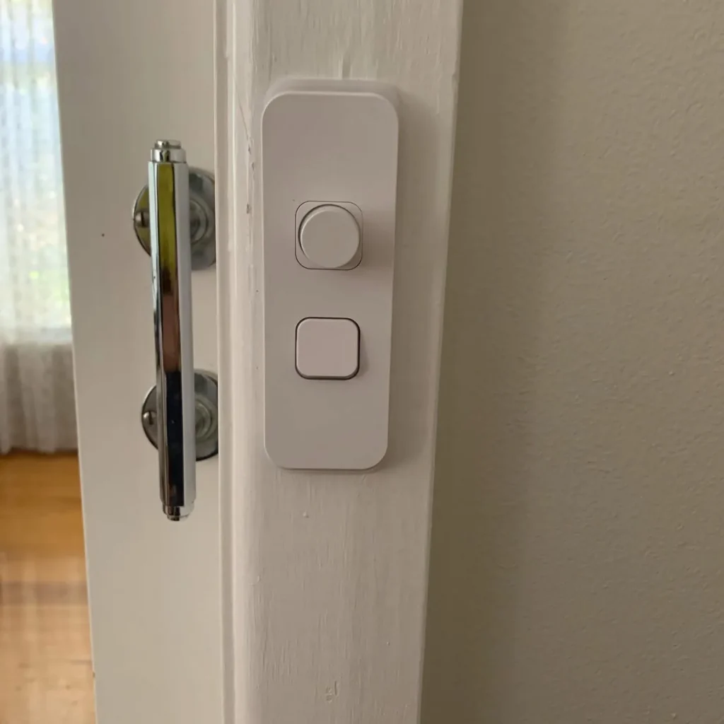 New flush light switch plate on a door frame