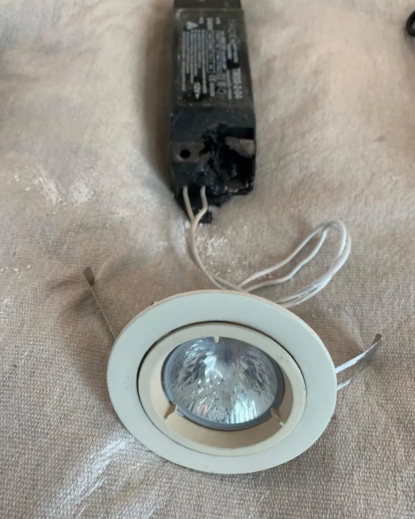 Old halogen downlight removed from a ceiling