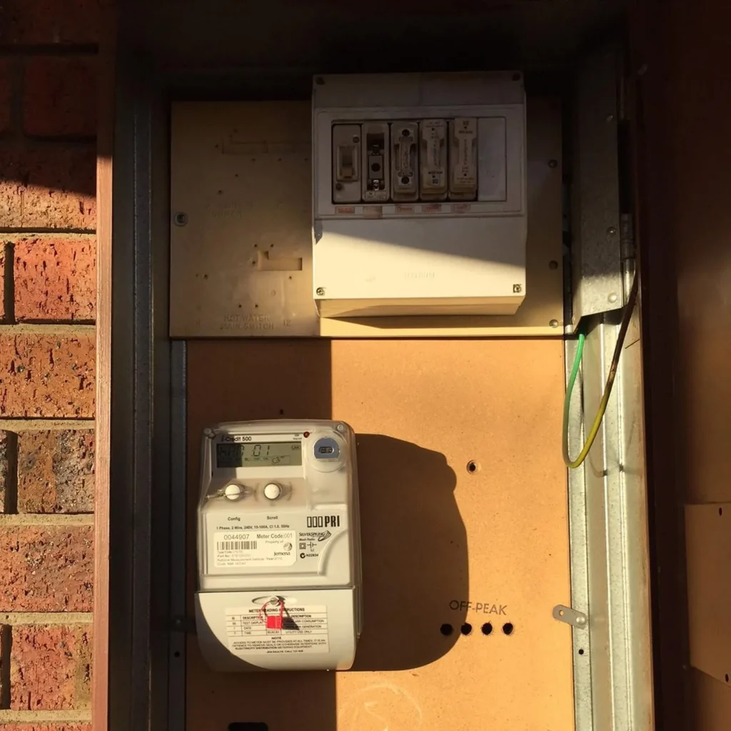 Meter panel with an older fuse unit above the electricity meter