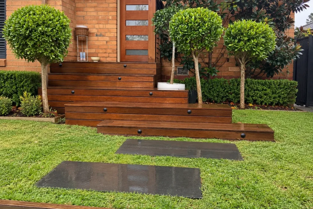 The same timber entry steps and front garden in daylight with the lights off